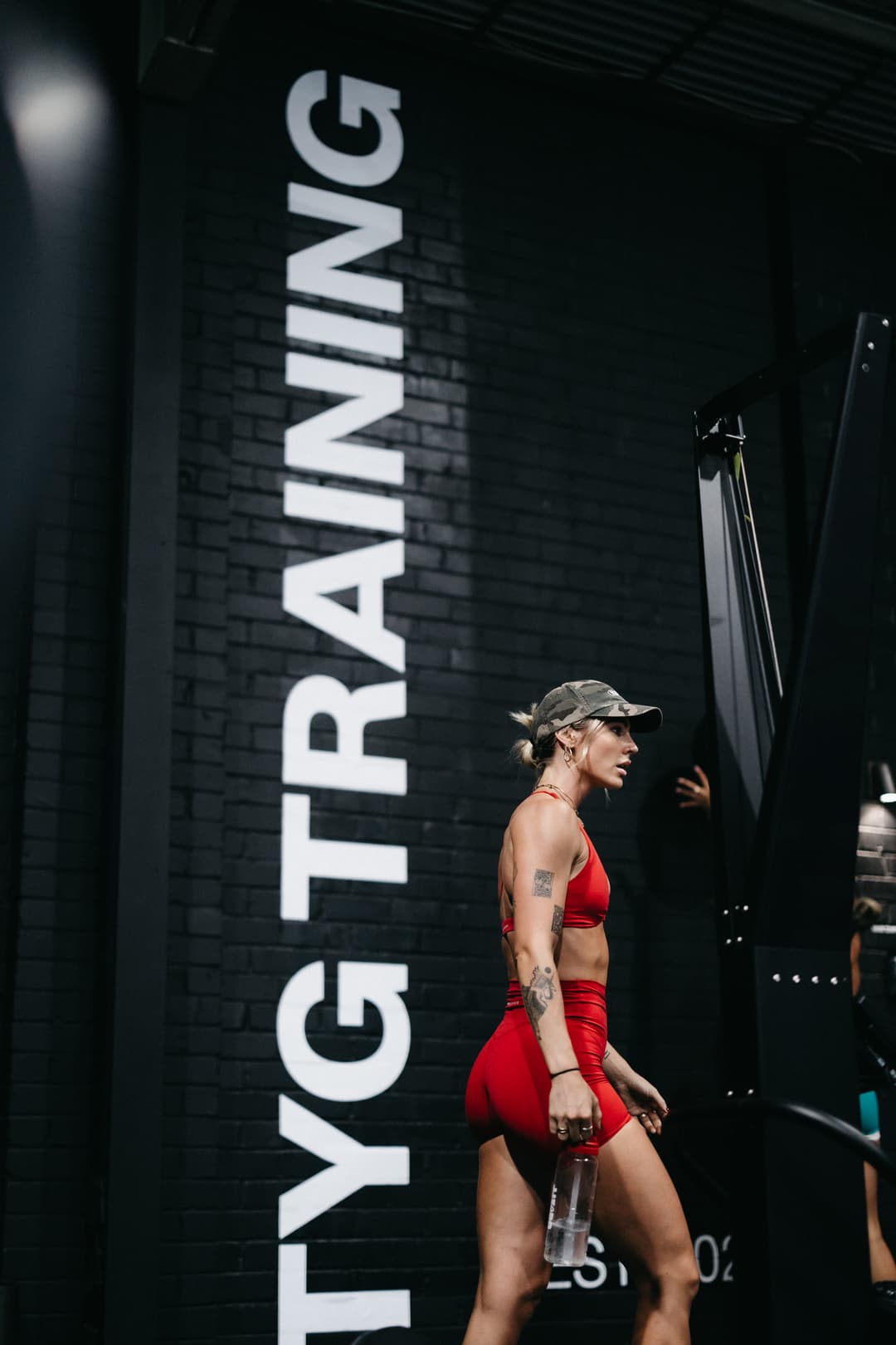 Female member training during a turf conditioning session in front of the iconic LED Yard Gym sign at The Yard Gym Somerton Park, South Australia.